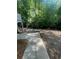 Spacious backyard area with a concrete patio and plenty of shade trees at 2166 Lake Ridge Ter, Lawrenceville, GA 30043