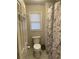 Bathroom with toilet and shower with marble curtain at 2166 Lake Ridge Ter, Lawrenceville, GA 30043