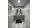 Bathroom featuring dual sinks with granite countertops, modern fixtures, and marble floors at 2166 Lake Ridge Ter, Lawrenceville, GA 30043