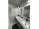 Bathroom featuring dual sinks with granite countertops, modern fixtures, and marble floors at 2166 Lake Ridge Ter, Lawrenceville, GA 30043