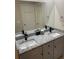 Bathroom with granite countertop on vanity and black fixtures, complemented by a large mirror at 2166 Lake Ridge Ter, Lawrenceville, GA 30043