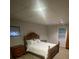 Comfortable bedroom with carpet flooring, wood furniture, and a bright window at 2166 Lake Ridge Ter, Lawrenceville, GA 30043