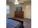 Bedroom with a large dresser under a television, and a ceiling fan at 2166 Lake Ridge Ter, Lawrenceville, GA 30043