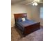 Comfortable bedroom with a dark wood bed frame and matching bedside tables at 2166 Lake Ridge Ter, Lawrenceville, GA 30043