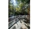 Wooden deck features a white railing and a view of the surrounding woods at 2166 Lake Ridge Ter, Lawrenceville, GA 30043