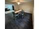The dining room has a table with four chairs, dark wood floors, and an open archway leading into the living room at 2166 Lake Ridge Ter, Lawrenceville, GA 30043