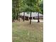 Ranch-style house with a two-car garage and mature trees in the backyard at 2166 Lake Ridge Ter, Lawrenceville, GA 30043