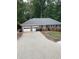 Brick house with attached two-car garage and a concrete driveway at 2166 Lake Ridge Ter, Lawrenceville, GA 30043