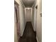 Hallway with dark wood floor and neutral walls leads to multiple rooms at 2166 Lake Ridge Ter, Lawrenceville, GA 30043