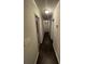 Neutral hallway leading to a bright bedrooms with neutral walls and dark floors at 2166 Lake Ridge Ter, Lawrenceville, GA 30043