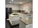 Bright kitchen featuring white cabinets, granite counters, and a large island at 2166 Lake Ridge Ter, Lawrenceville, GA 30043