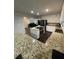 Modern kitchen with white cabinets, stainless steel appliances, and granite countertops at 2166 Lake Ridge Ter, Lawrenceville, GA 30043
