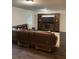 Open-concept living room featuring a large, dark entertainment center and a comfortable-looking leather sofa at 2166 Lake Ridge Ter, Lawrenceville, GA 30043