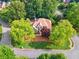 Aerial view of a home with mature trees, showcasing the well-manicured lawn and landscape at 4750 Freeport Bay Ne, Roswell, GA 30075