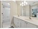 Bright bathroom with a double sink vanity, white cabinetry, and a view of the tub and toilet rooms at 4750 Freeport Bay Ne, Roswell, GA 30075