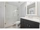 Bright bathroom featuring a glass shower, a modern vanity with dark wood cabinets, and a white countertop at 4750 Freeport Bay Ne, Roswell, GA 30075