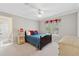 Cozy bedroom with a full bed, plush carpeting, and a sunlit window with festive decor at 4750 Freeport Bay Ne, Roswell, GA 30075