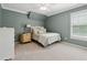 Charming bedroom with a patterned bedspread, soft carpet, and a serene color palette at 4750 Freeport Bay Ne, Roswell, GA 30075