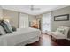 Tranquil bedroom with dark wood floors, a four-poster bed, and natural light filtering through sheer curtains at 4750 Freeport Bay Ne, Roswell, GA 30075