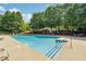 Community pool with plenty of seating and lush landscaping for a relaxing outdoor experience at 4750 Freeport Bay Ne, Roswell, GA 30075
