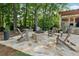 Outdoor stone fire pit with Adirondack chairs, creating a cozy backyard retreat at 4750 Freeport Bay Ne, Roswell, GA 30075