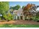 Charming home showcasing a stone and siding facade, well-manicured lawn and a mature landscape at 4750 Freeport Bay Ne, Roswell, GA 30075