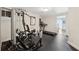 Home gym with exercise machines, rubber flooring, and access to a bright living area at 4750 Freeport Bay Ne, Roswell, GA 30075