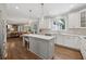 Modern kitchen features a large island with pendant lighting, stainless steel appliances, and hardwood floors at 4750 Freeport Bay Ne, Roswell, GA 30075