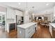 Modern kitchen with white cabinets, an island, stainless appliances, and hardwood floors at 4750 Freeport Bay Ne, Roswell, GA 30075