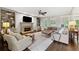 Inviting living room features a stone fireplace, built-in shelving, and plush seating at 4750 Freeport Bay Ne, Roswell, GA 30075
