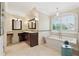 Bright bathroom featuring a soaking tub, double vanity and plantation shutters at 4750 Freeport Bay Ne, Roswell, GA 30075