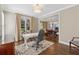 Home office with natural light and hardwood floors offers view into dining room at 4750 Freeport Bay Ne, Roswell, GA 30075