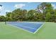 Full tennis court with lush green surroundings for recreational enjoyment at 4750 Freeport Bay Ne, Roswell, GA 30075