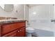 A compact bathroom features a vanity with a matching countertop and a combined shower-tub at 61 Springside Se Dr, Atlanta, GA 30354