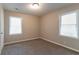 This cozy bedroom has bright windows, a neutral color palette, and plush carpeting at 61 Springside Se Dr, Atlanta, GA 30354