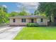 Charming brick home with a well-manicured lawn, inviting curb appeal, and beautiful landscaping at 61 Springside Se Dr, Atlanta, GA 30354
