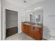 Bathroom featuring double sinks, granite countertop, and walk-in closet for convenient storage at 943 Peachtree Ne St # 1518, Atlanta, GA 30309