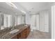 Bathroom with double vanity, granite countertop, and tub with white subway tile surround at 943 Peachtree Ne St # 1518, Atlanta, GA 30309
