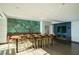 Spacious dining room with a long communal table, stylish chairs, and a unique accent wall at 943 Peachtree Ne St # 1518, Atlanta, GA 30309