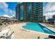 Outdoor pool area with lounge chairs and umbrellas, perfect for relaxation and enjoyment at 943 Peachtree Ne St # 1518, Atlanta, GA 30309