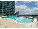 Beautiful outdoor swimming pool surrounded by lounge chairs and a luxury building reflecting in the water at 943 Peachtree Ne St # 1518, Atlanta, GA 30309