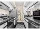 Efficient kitchen featuring stainless steel appliances, tile floor, and modern lighting at 1 Biscayne Nw Dr # 804, Atlanta, GA 30309