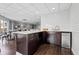 Common room kitchenette area featuring modern cabinets, stainless steel mini-fridge, sink, and subway tile backsplash at 1 Biscayne Nw Dr # 804, Atlanta, GA 30309