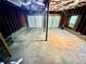 Unfinished basement with concrete floors, exposed rafters, and two garage doors at 186 Grapevine Dr, Douglasville, GA 30134