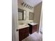 Bathroom features double sinks with dark cabinets and a tile floor at 186 Grapevine Dr, Douglasville, GA 30134