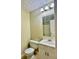 Well-lit bathroom with a single sink vanity, toilet, and tiled floors at 186 Grapevine Dr, Douglasville, GA 30134
