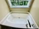 Bathroom soaking tub features a view from the window at 186 Grapevine Dr, Douglasville, GA 30134