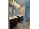 Bathroom showcasing double sink vanity cabinets with dark wood and a windowed corner tub at 186 Grapevine Dr, Douglasville, GA 30134