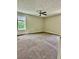 Spacious bedroom featuring neutral paint, textured ceiling with fan, and a window for natural light at 186 Grapevine Dr, Douglasville, GA 30134
