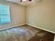Neutral painted bedroom with a large window allowing natural light to illuminate the room at 186 Grapevine Dr, Douglasville, GA 30134
